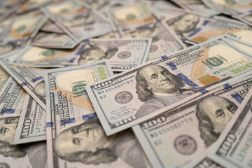 Scattered hundred dollar bills