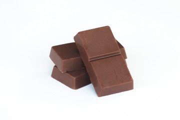 Chopped chocolate bars on white background