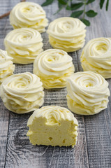 Yellow, apple marshmallow with lemon on wooden vintage background.