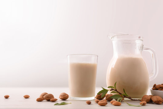Healthy nutrition with almond drink in glass and glass jar