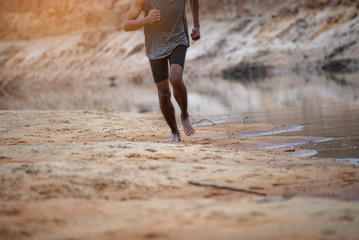 Athlete active man running outside road with sprint speed.Runner exercise sport traning to...