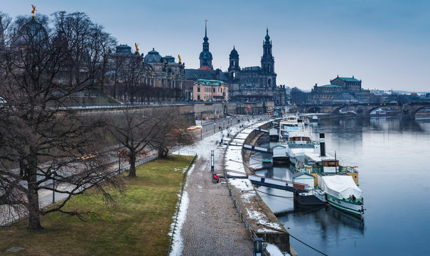Panoramic image of Dresden, Germany during et the winter evening with Elbe River in the foreground.