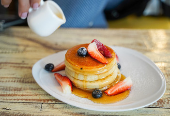 Stack of homemade pancakes for breakfast with berries