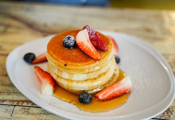 Stack of homemade pancakes for breakfast with berries