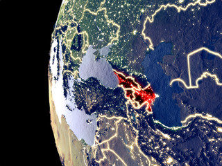Night view of Caucasus region from space with visible city lights. Very detailed plastic planet surface.