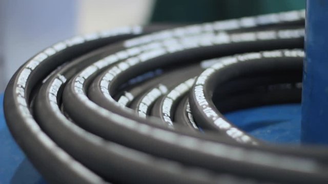 Industrial hose is wound in hank during production process. Manufacture of hoses