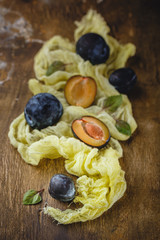 Plums on wooden background