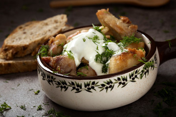 Pieces of fried chicken meat white cream sauce and chopped dill
