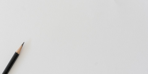 closeup on black pencil on white watercolor paper sketch page for design concept