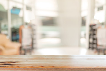 Wooden desk with Abstract blurred livingroom decoration interior for background