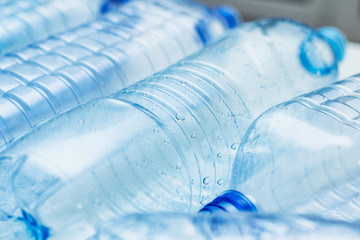 Blue used plastic bottles. Recycle concept. Clear bottles on white background. Making process. 