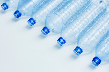 Blue used plastic bottles. Recycle concept. Clear bottles on white background. Making process. 