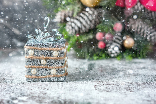 Silver and white xmas ornaments on rustic wood background. Merry christmas card. Space for text.