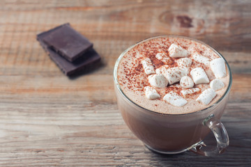 cup of hot cocoa with marshmallows on wooden background