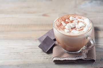 cup of hot cocoa with marshmallows on wooden background