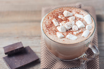 cup of hot cocoa with marshmallows on wooden background