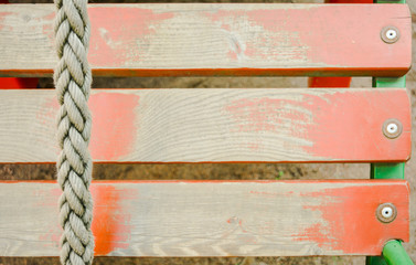 Old rope and distressed red painted wood planks