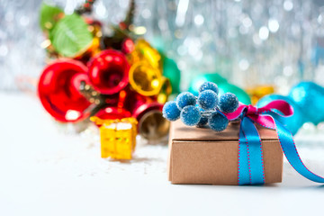 Christmas gift box with ribbon and christmas decoration on a white background
