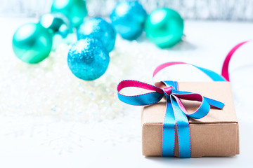 Christmas gift box with ribbon and christmas decoration on a white background