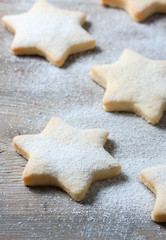 Fototapeta na wymiar Homemade star shaped cookies on a wooden background. Christmas decoration