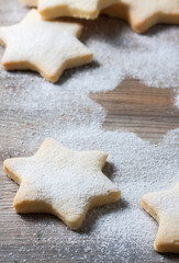 Homemade star shaped cookies on a wooden background. Christmas decoration