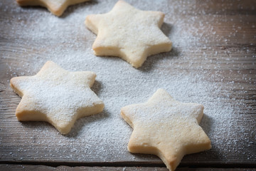 Homemade star shaped cookies on a wooden background. Christmas decoration