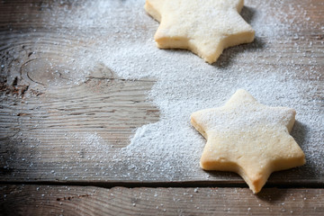 Homemade star shaped cookies on a wooden background. Christmas decoration