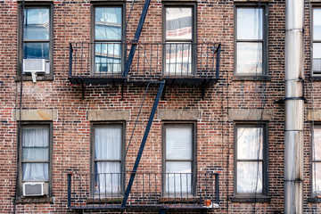 Old brick building with balconies and fire escape