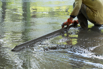 Construction worker is pouring concrete floors, Building construction on site with labor, Home building concept