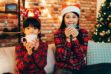 happy family holding cup drinking on sofa