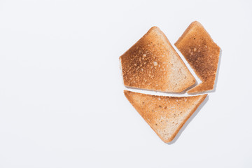 top view of heart shape made of toast on white surface