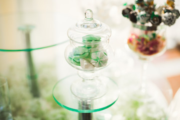 Delicious sweets on wedding candy buffet with desserts, cupcakes