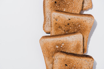 top view of stack of crunchy toasts on white surface