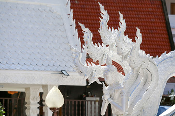 The art of Thai culture, stucco, white Naga decorated by the roof of the church and stairs