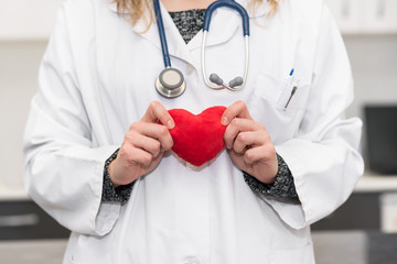 Doctor holding a red heart shape