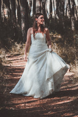 Stylish young bride posing in the woods