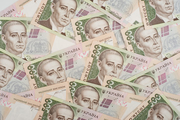 A close-up of a pattern of many Ukrainian currency banknotes with a par value of 500 hryvnia. Background image on business in Ukraine