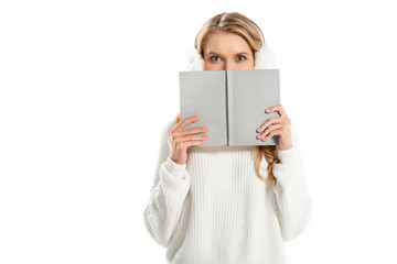 happy girl hiding behind the book isolated on white