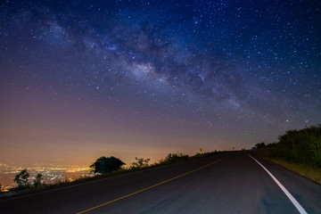 Fototapeta premium night landscape road on mountain and milky way galaxy background ,Thailand , long exposure , low light