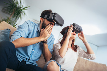 Young man and woman in casual clothes wear the virtual reality glasses are watching and showing imagine via the VR camera, Technology and innovation concept