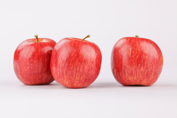 Three red apples on the table