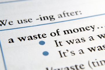 Waste of money phrase in English textbook Selective focus