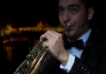 French horn player. Hornist playing brass orchestra music instrument.