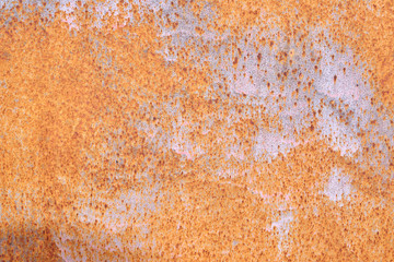 Rusted painted metal wall. Rusty metal background with streaks of rust. Rust stains. The metal surface rusted spots