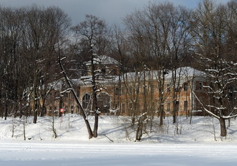 An orange conservatory on the bank of a pond in the Moscow historical park Kuzminki