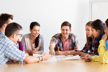 education, architecture and people concept - group of smiling students meeting at school