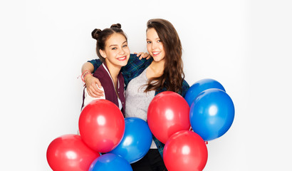 Fototapeta na wymiar american independence day, holiday and birthday party concept - happy smiling pretty teenage girls with red and blue helium balloons over white background