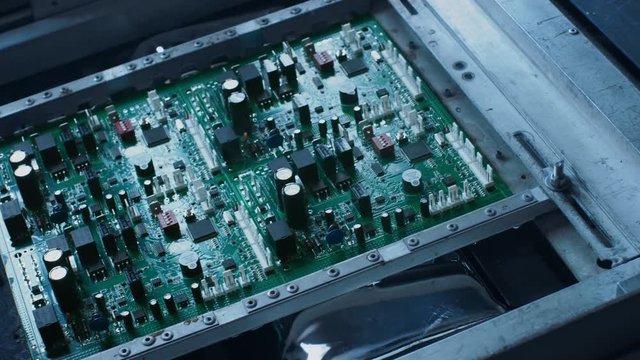 Electronic Printed Circuit Board with Microchips, Transistors, Semiconductors, Capacitors Water Cooling Process on the Assembly Line During Manufacturing.