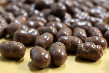 Crispy chocolate candies on table. Focus on foreground, blurred background.