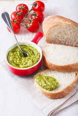bread with pesto on a wooden background.